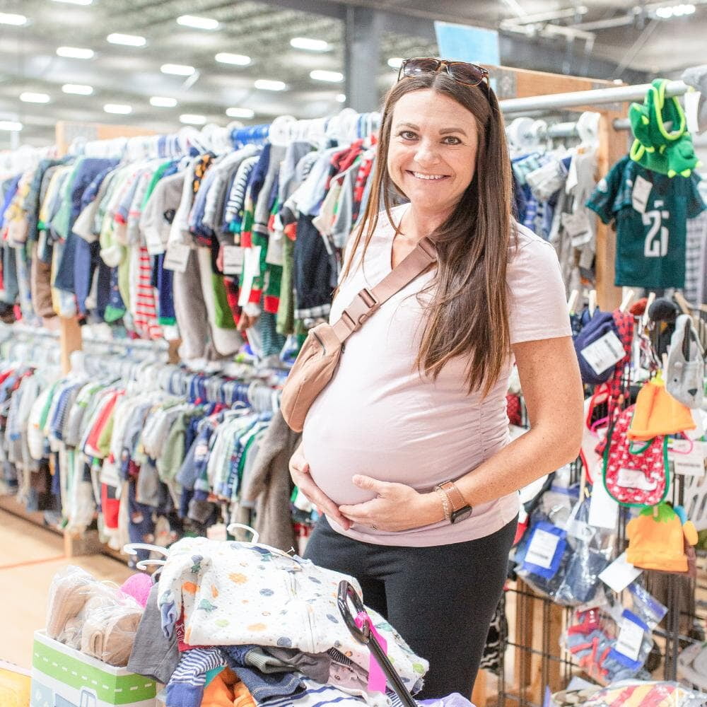 A pregmant Mom shopping with her wagon at JBF.