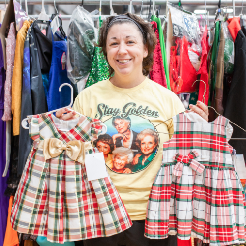 Mom holds dresses up from JBF.